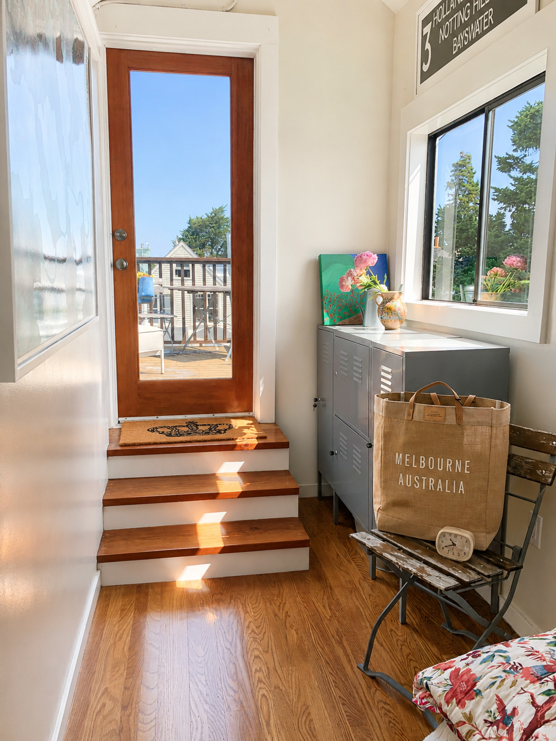 Sunlit entry with a glazed door opening onto a rooftop deck